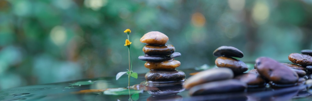 Stacked zen stones and a yellow flower